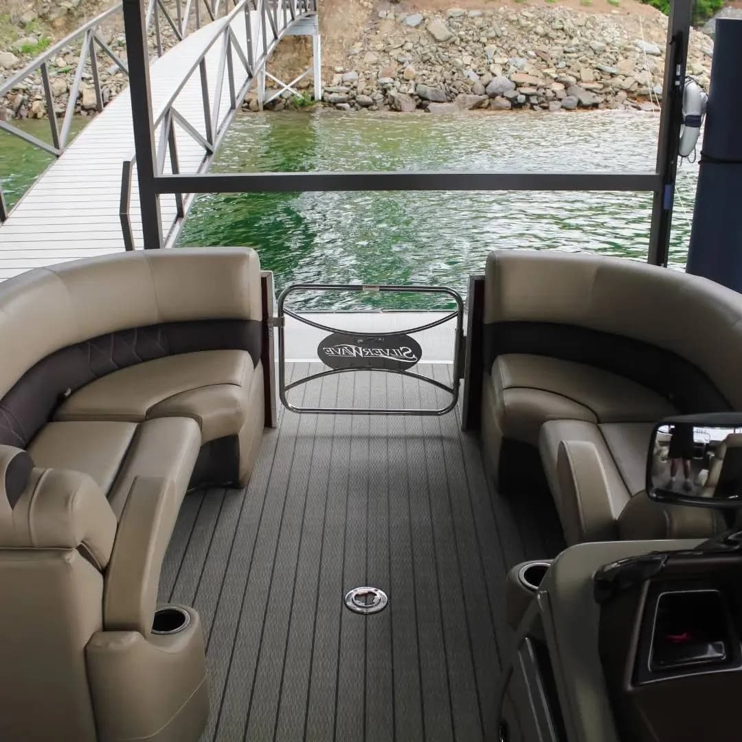 Pontoon deck with gray grooved foam flooring and tan lounge seating
